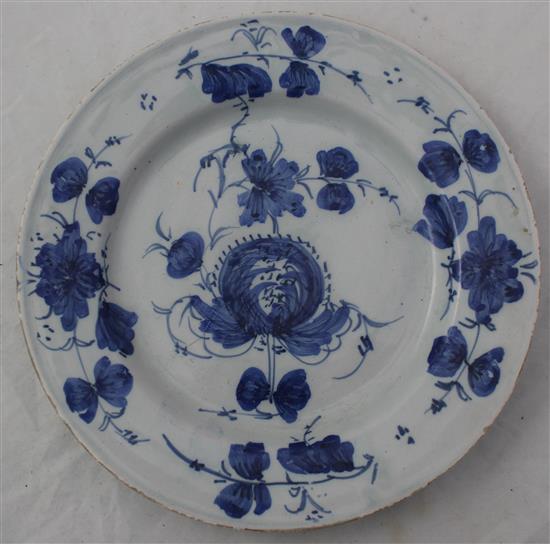 A Glasgow delft ware charger and a similar plate, late 18th century, 35.5cm and 22.5cm, hairline crack to charger